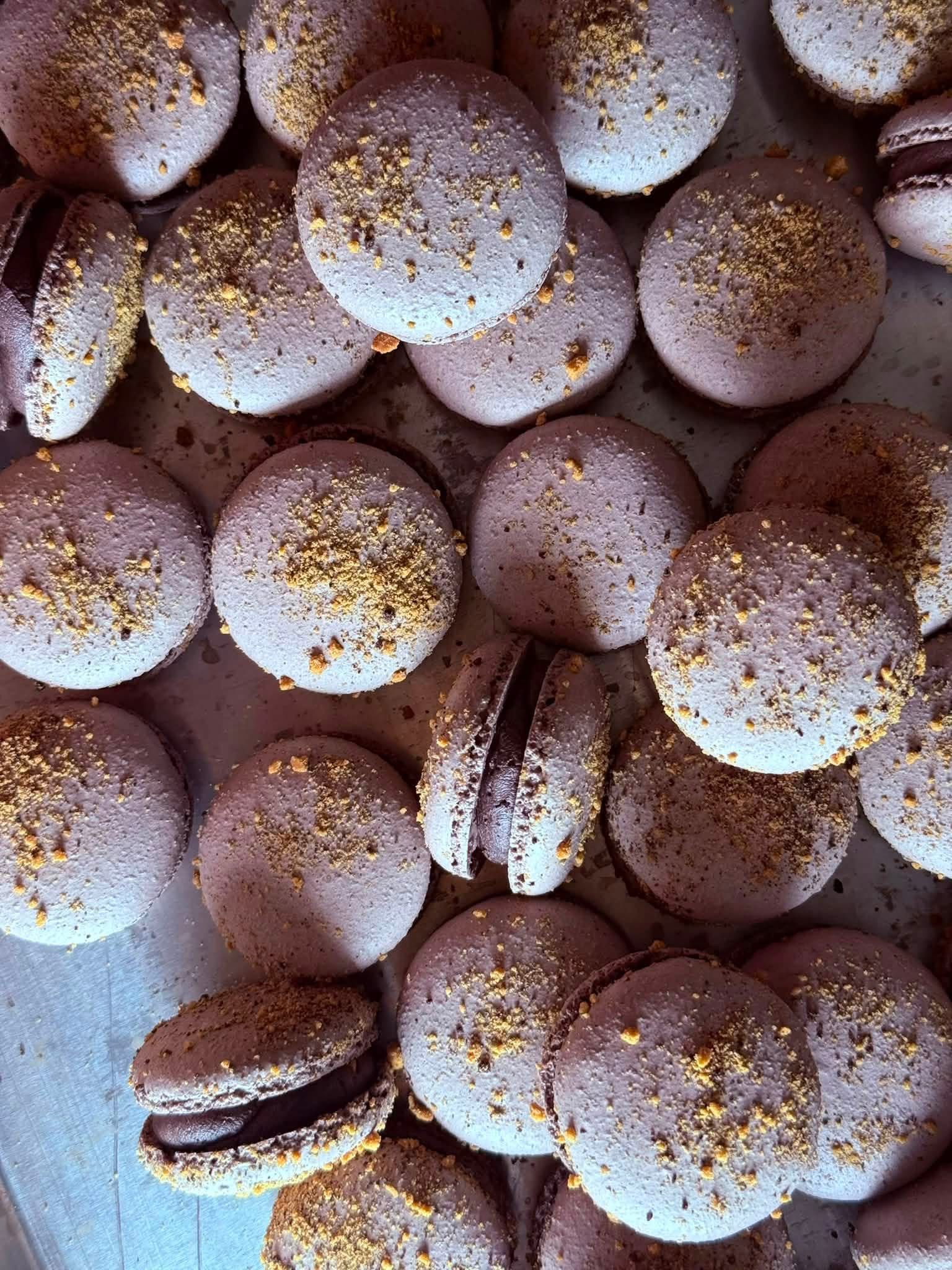 A styled dessert display featuring pastel French macarons